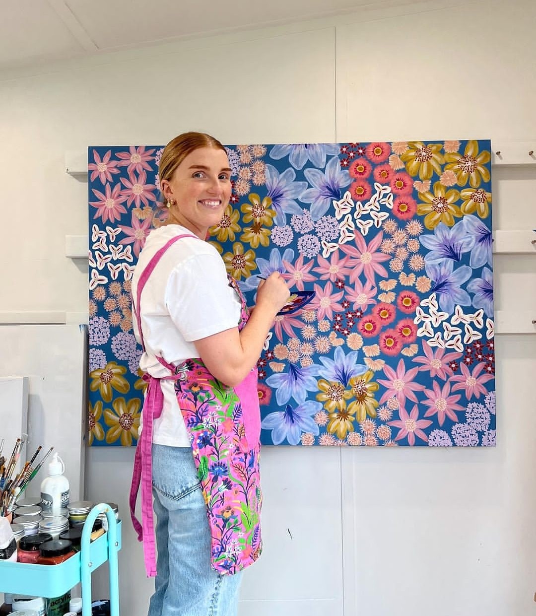 Amy Gibbs painting colourful floral artwork