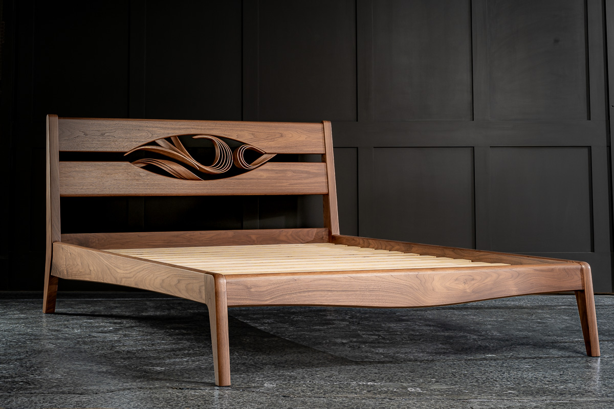 Walnut bed with curved timber detail