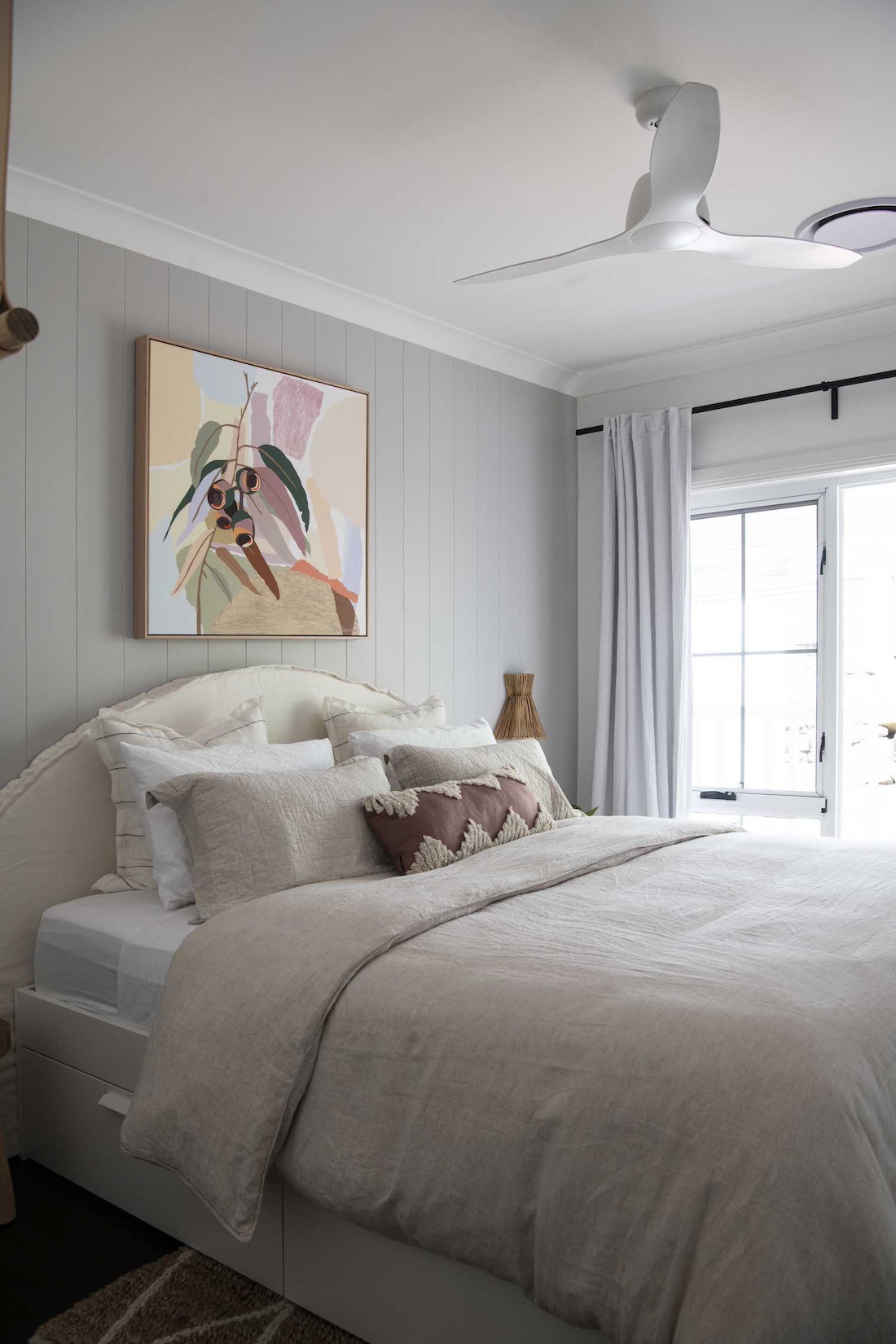 Bedroom with Australian art above bed