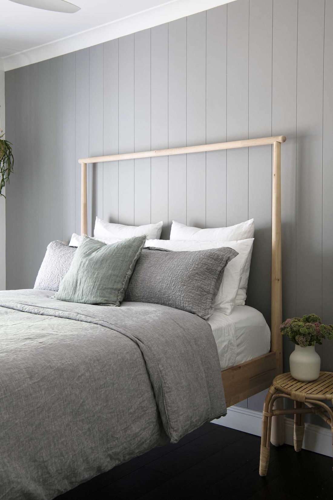 Timber framed bed with grey slatted wall