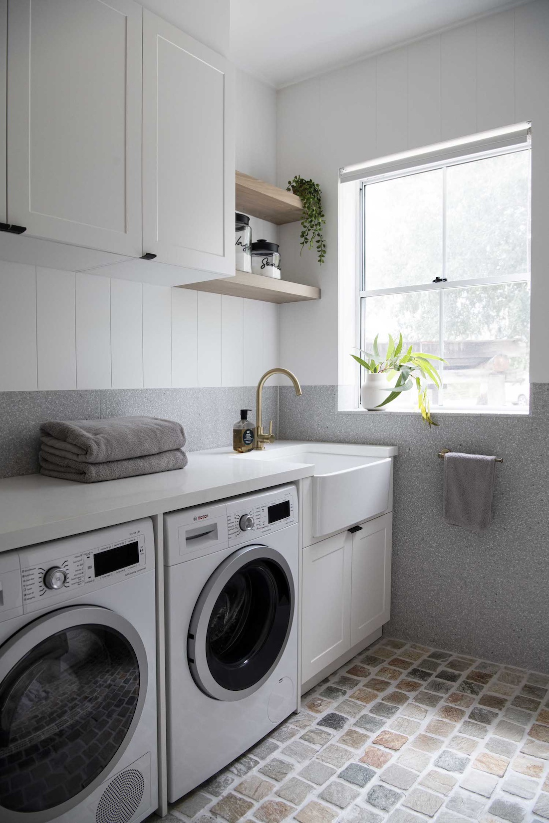 Laundry with butlers sink and cobblestone floors