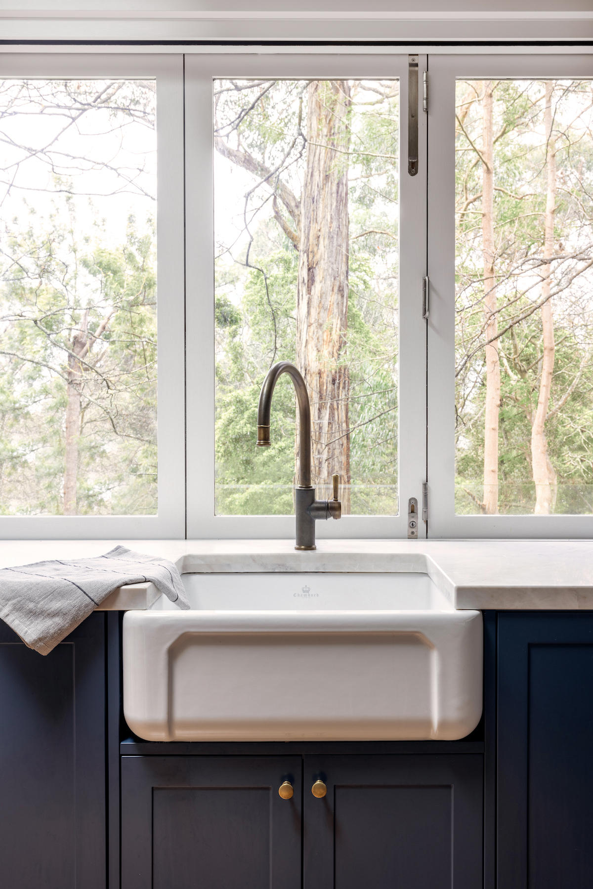 Butler's sink with aged brass tap in farmhouse meets contemporary style kitchen