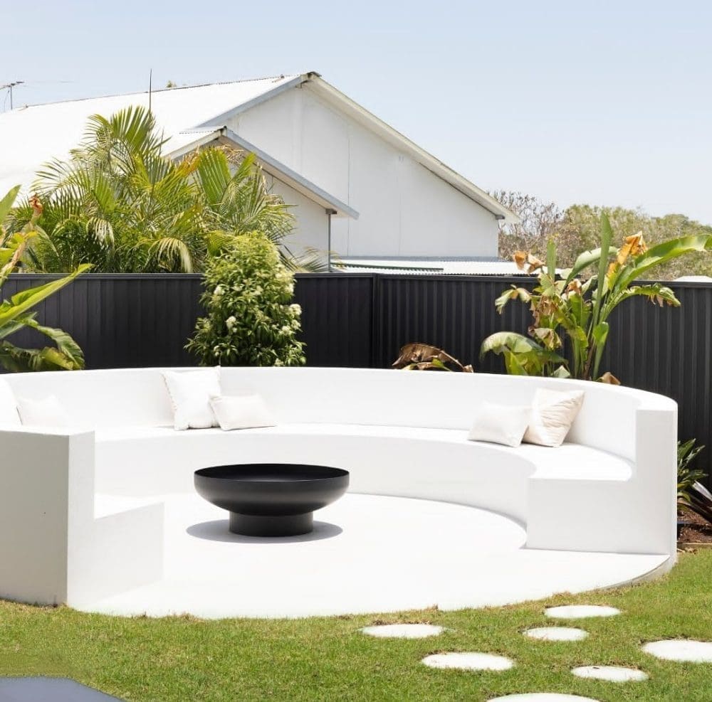 Black fire pit with white curved bench seat