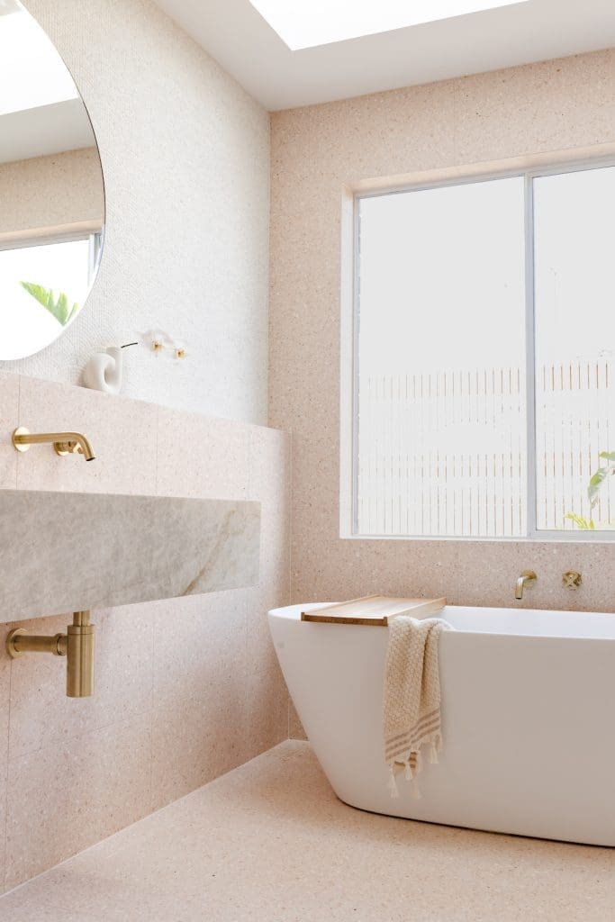 Solid stone freestanding bath under the window