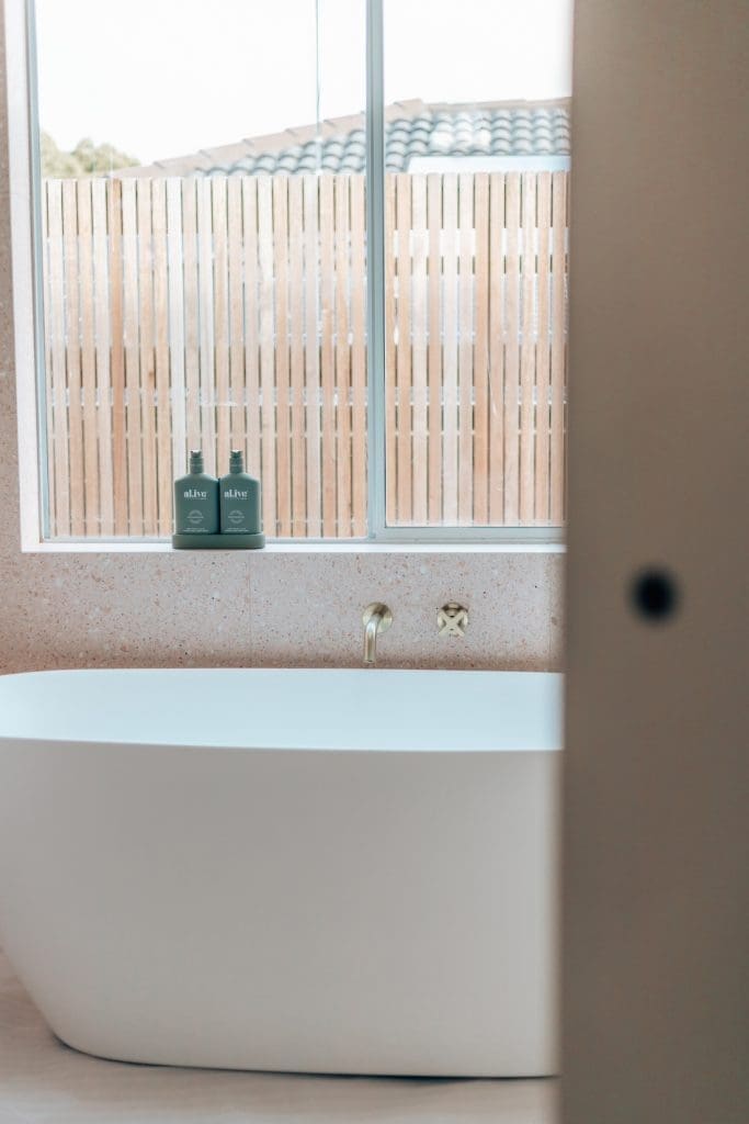Peeking into luxe bathroom with freestanding bath tub