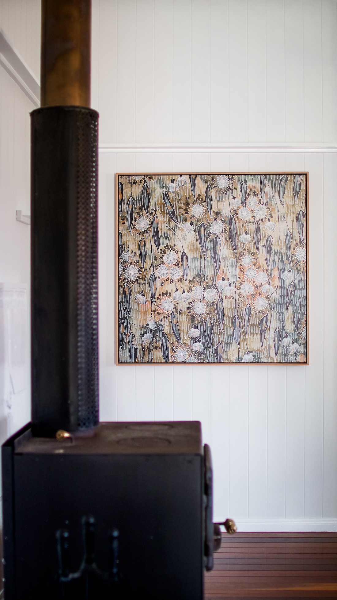 Summerholm House black wood burner in living room and floral art