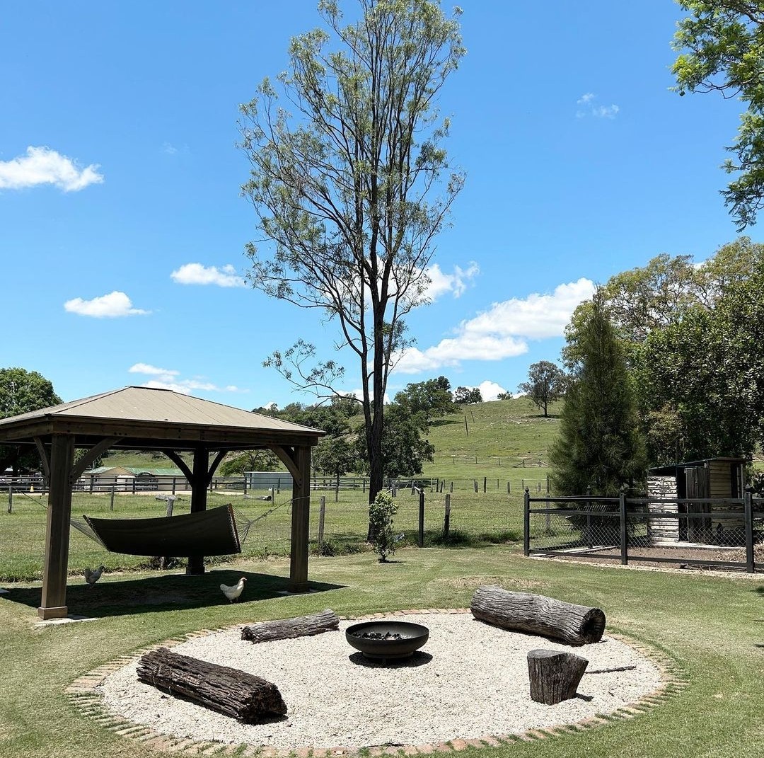 Summerholm House fire pit area with views of surrounding farm land