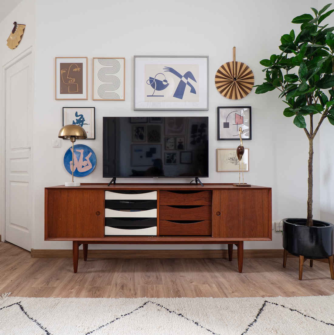 Vintage sideboard with graphic wall art by Aplotica Studio