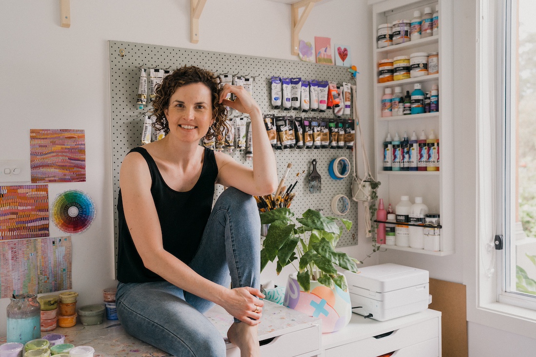 Sheree Smith sitting on her studio table