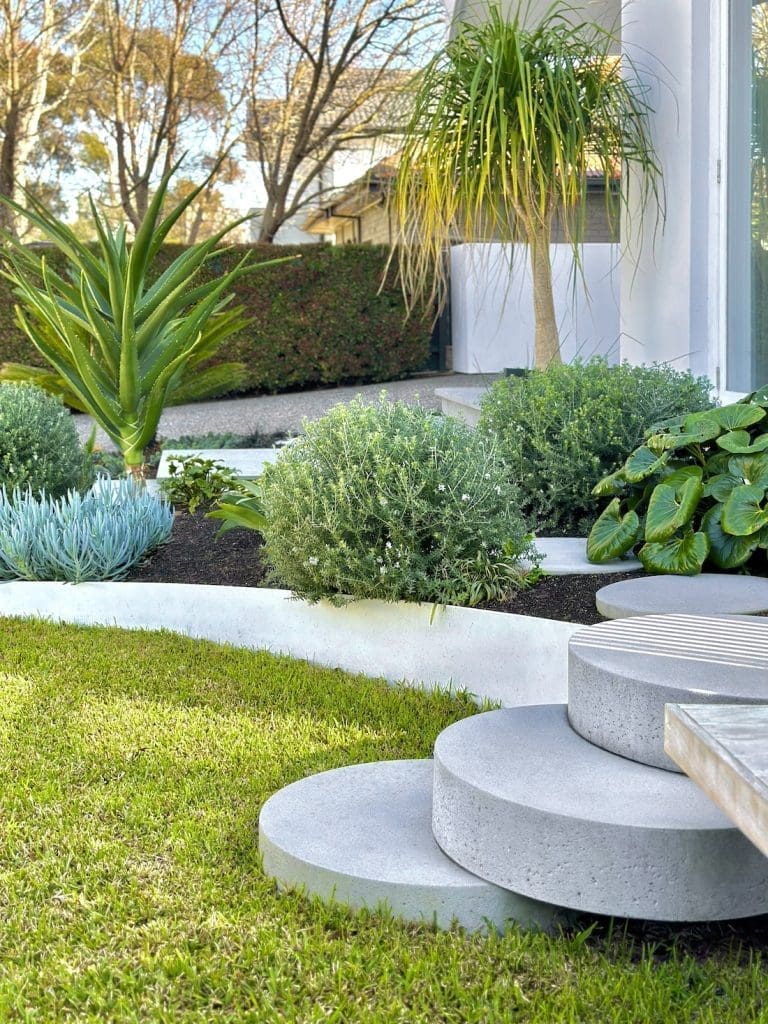 Round stepping stone steps in landscaped garden