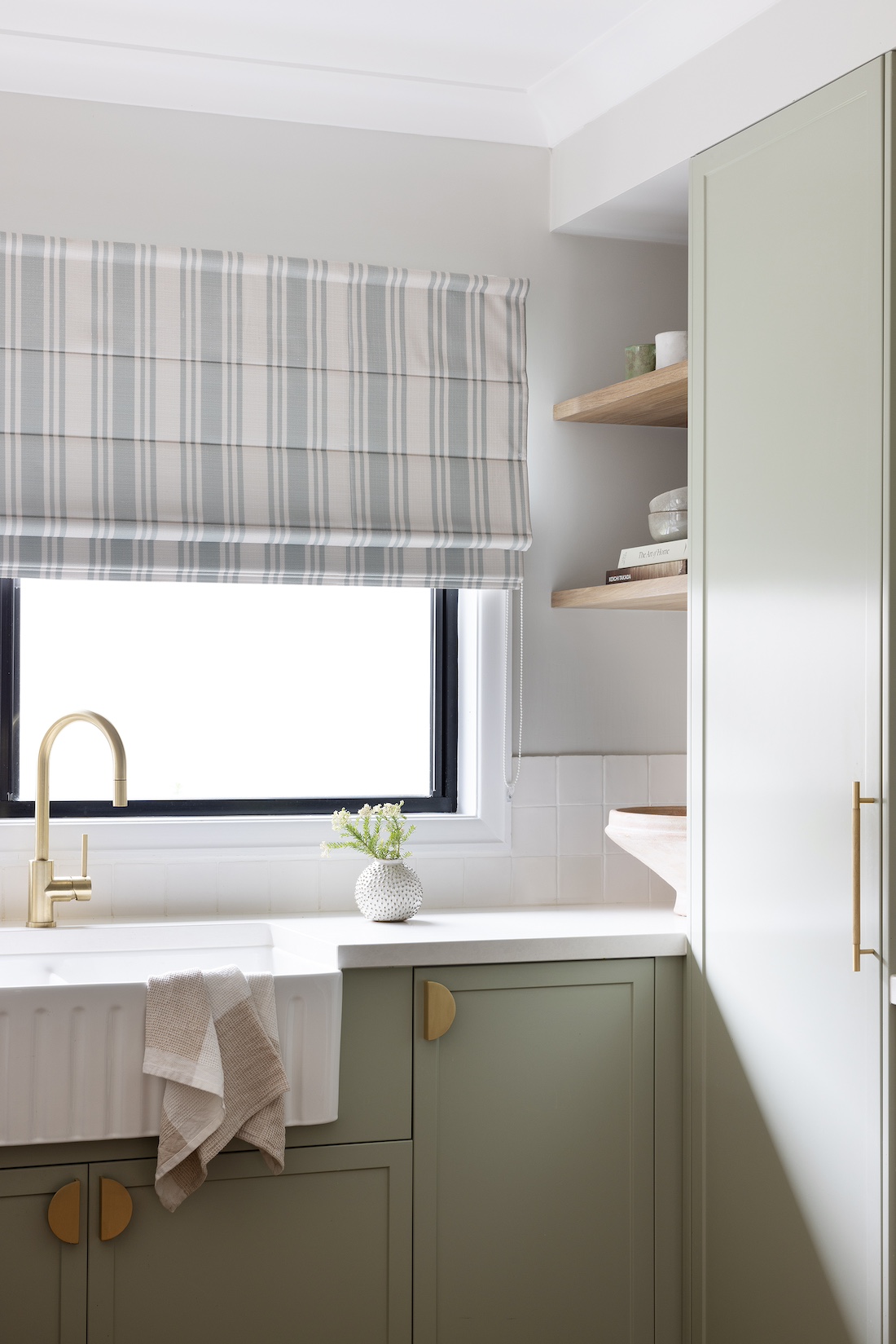 Farmhouse sink and striped blind in modern farmhouse kitchen