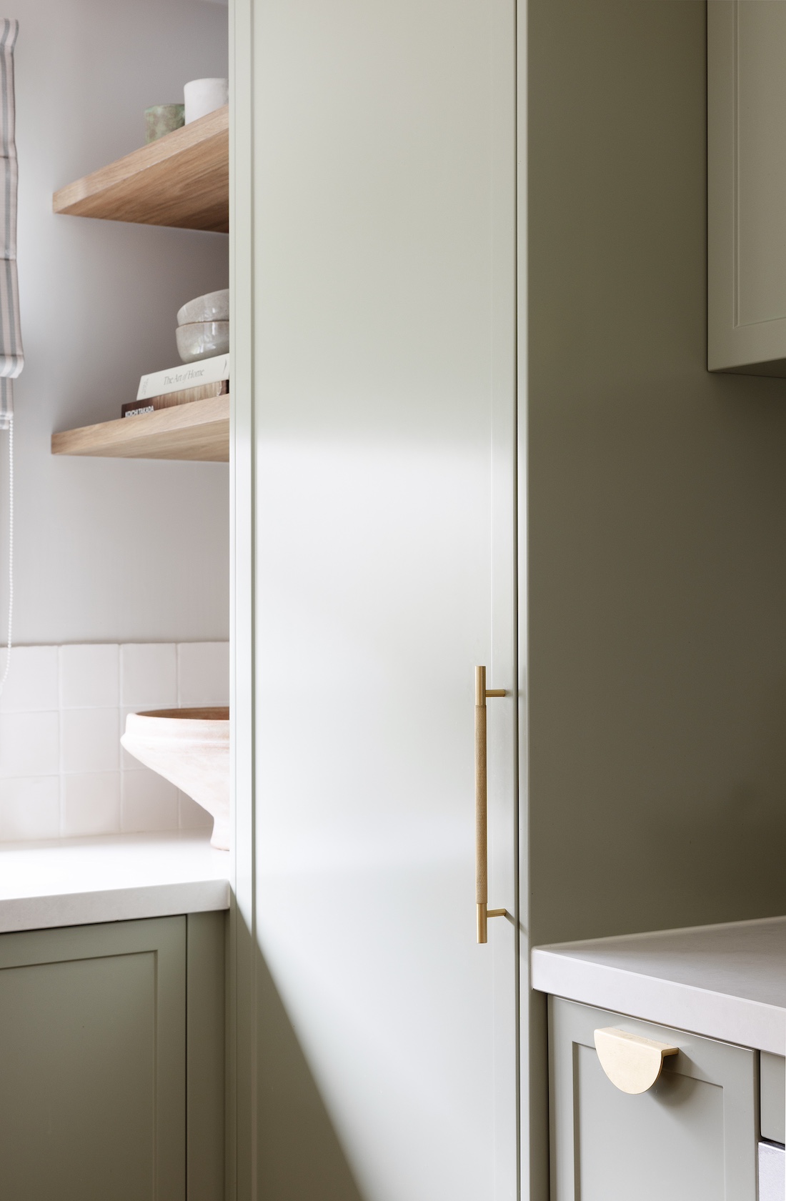 Green cabinetry in modern farmhouse kitchen