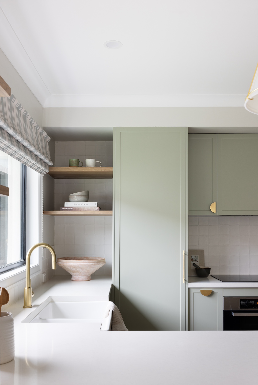 Green cabinetry in modern farmhouse kitchen