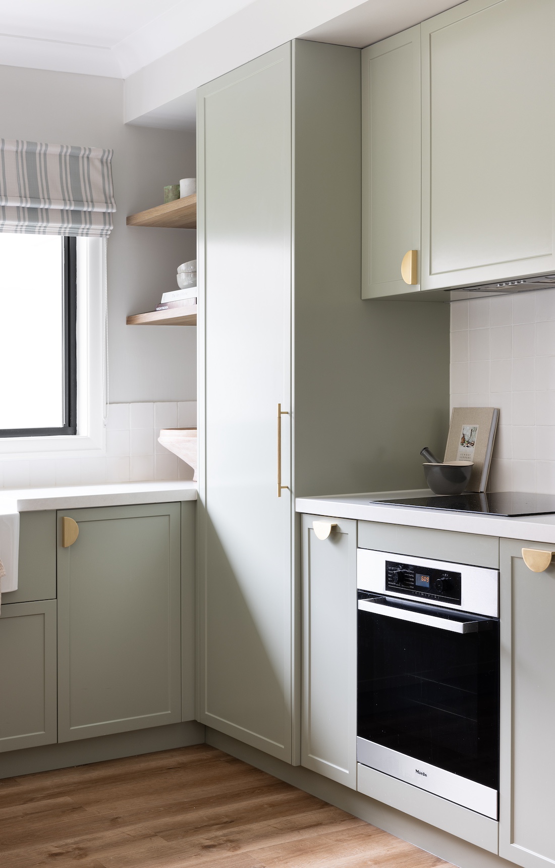 Green cabinetry in modern farmhouse kitchen