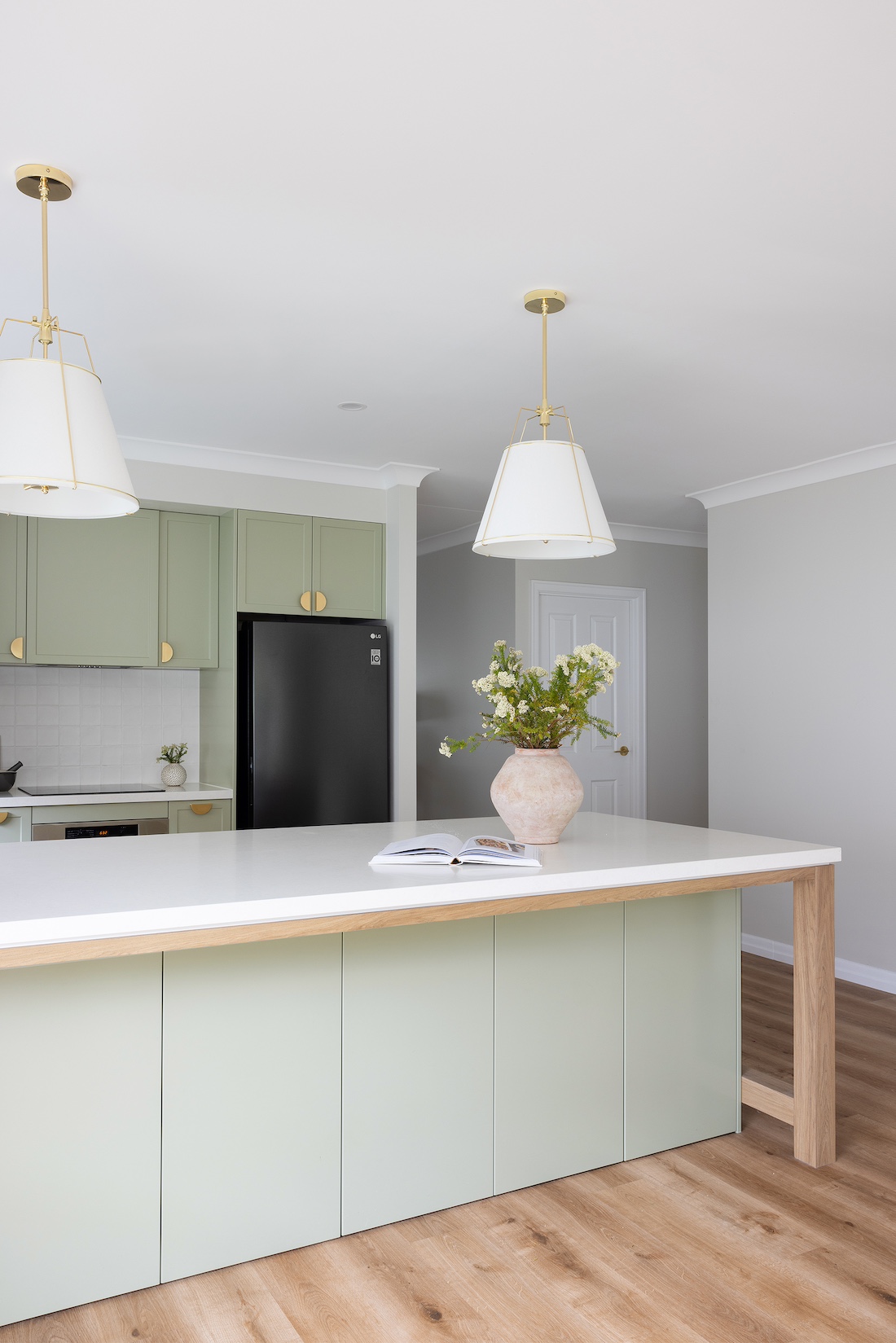 Green island bench cabinetry in modern farmhouse kitchen