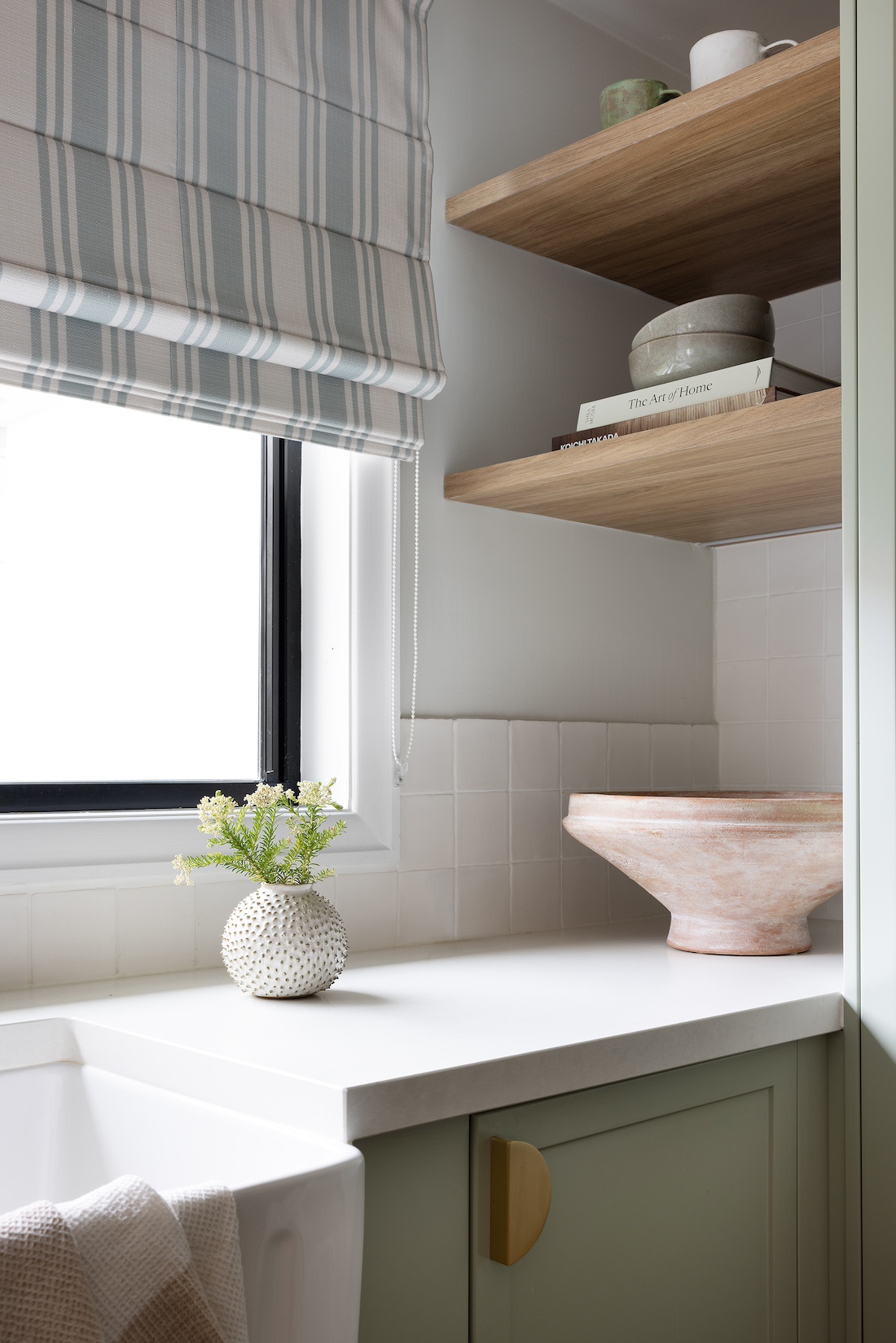 Timber floating shelves and striped blind in modern farmhouse kitchen