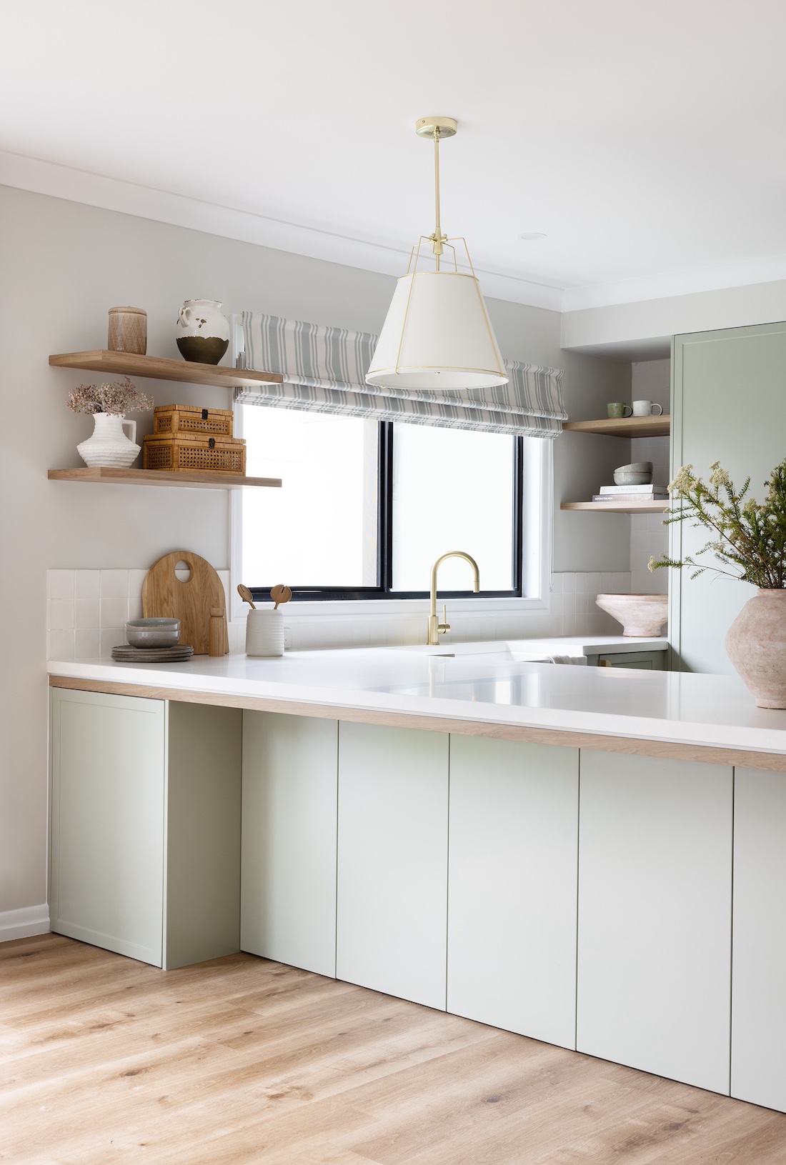 Green cabinetry in modern farmhouse kitchen