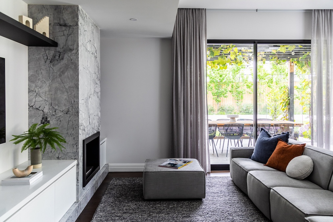 Marble fireplace in monochrome living from at Wattle Valley Road by Picchio Interiors