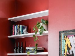 Red wall in living room with bar