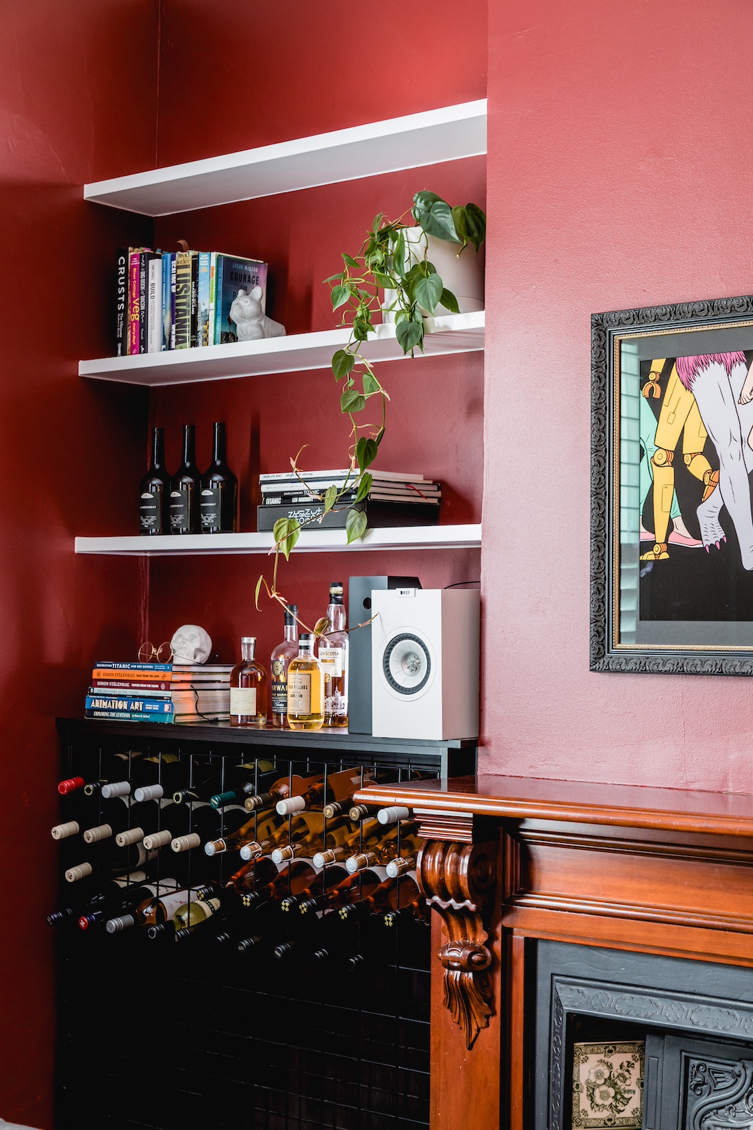 eclectic design accents and red wall in living room with bar