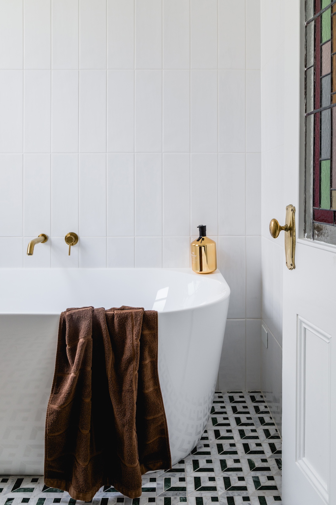 Carnegie Cottage patterned tile bathroom floor with standalone bath