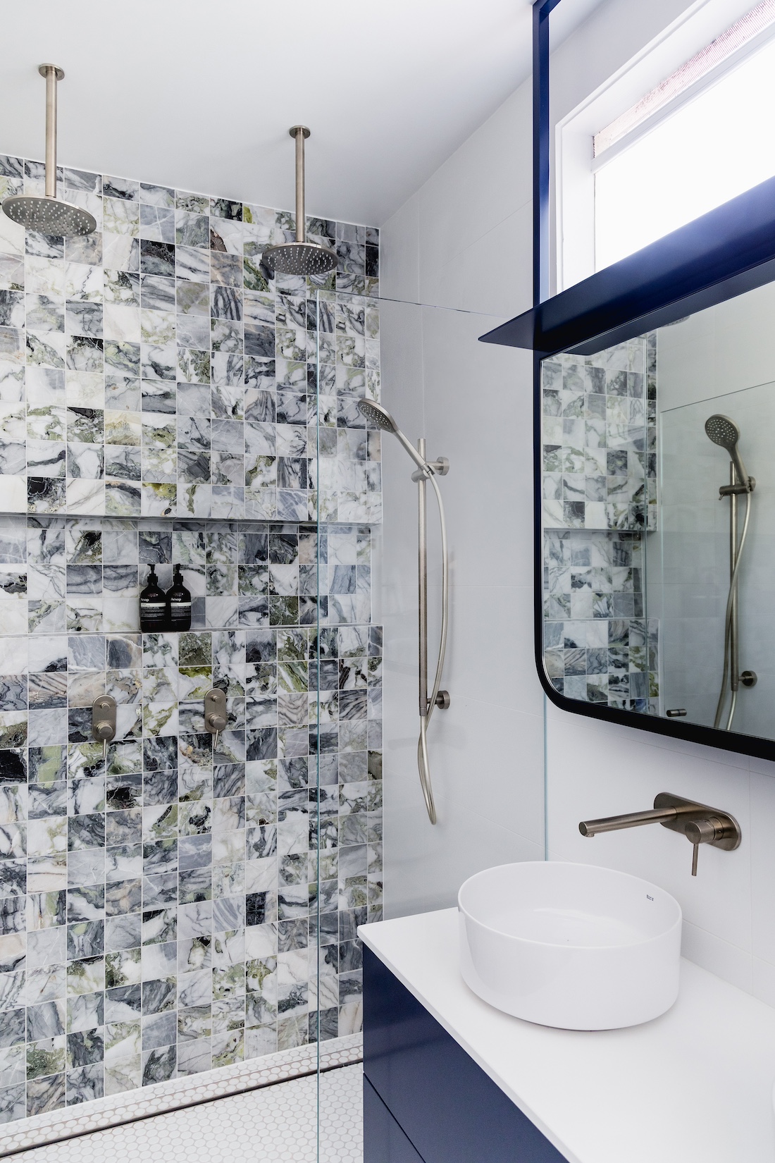 Marbled mosaic tiled shower in Carnegie Cottage eclectic design accents