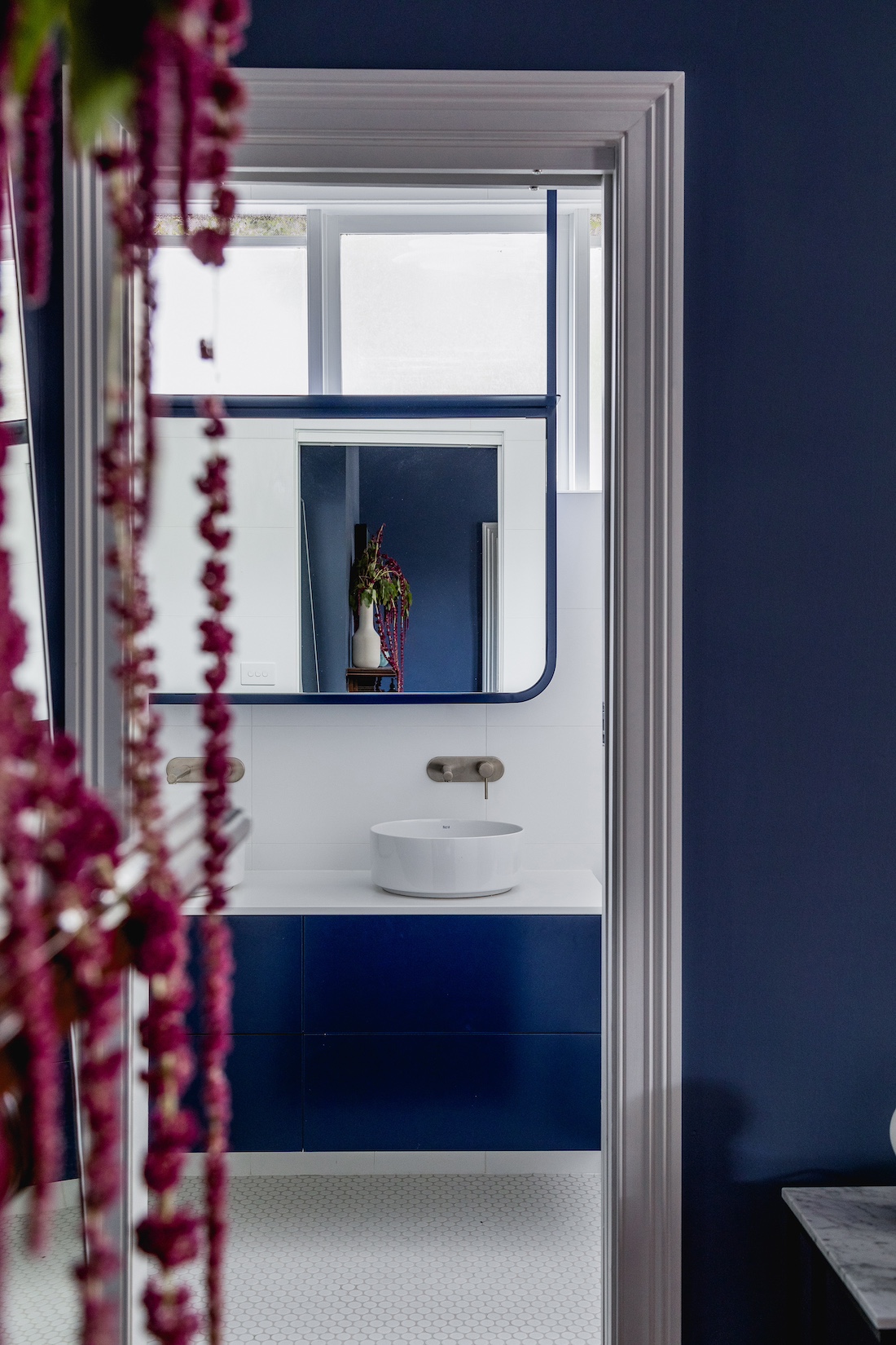 Navy blue bathroom wall and bedroom wall inside Carnegie Cottage