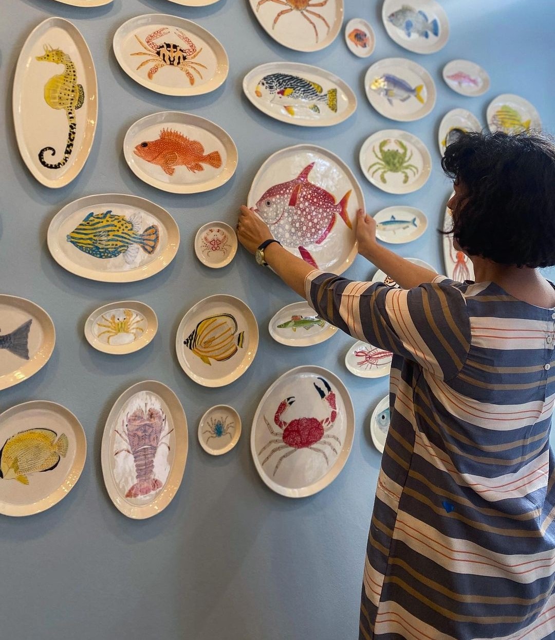 Wall of ceramic sea creature platters from Casa Adams Fine Wares