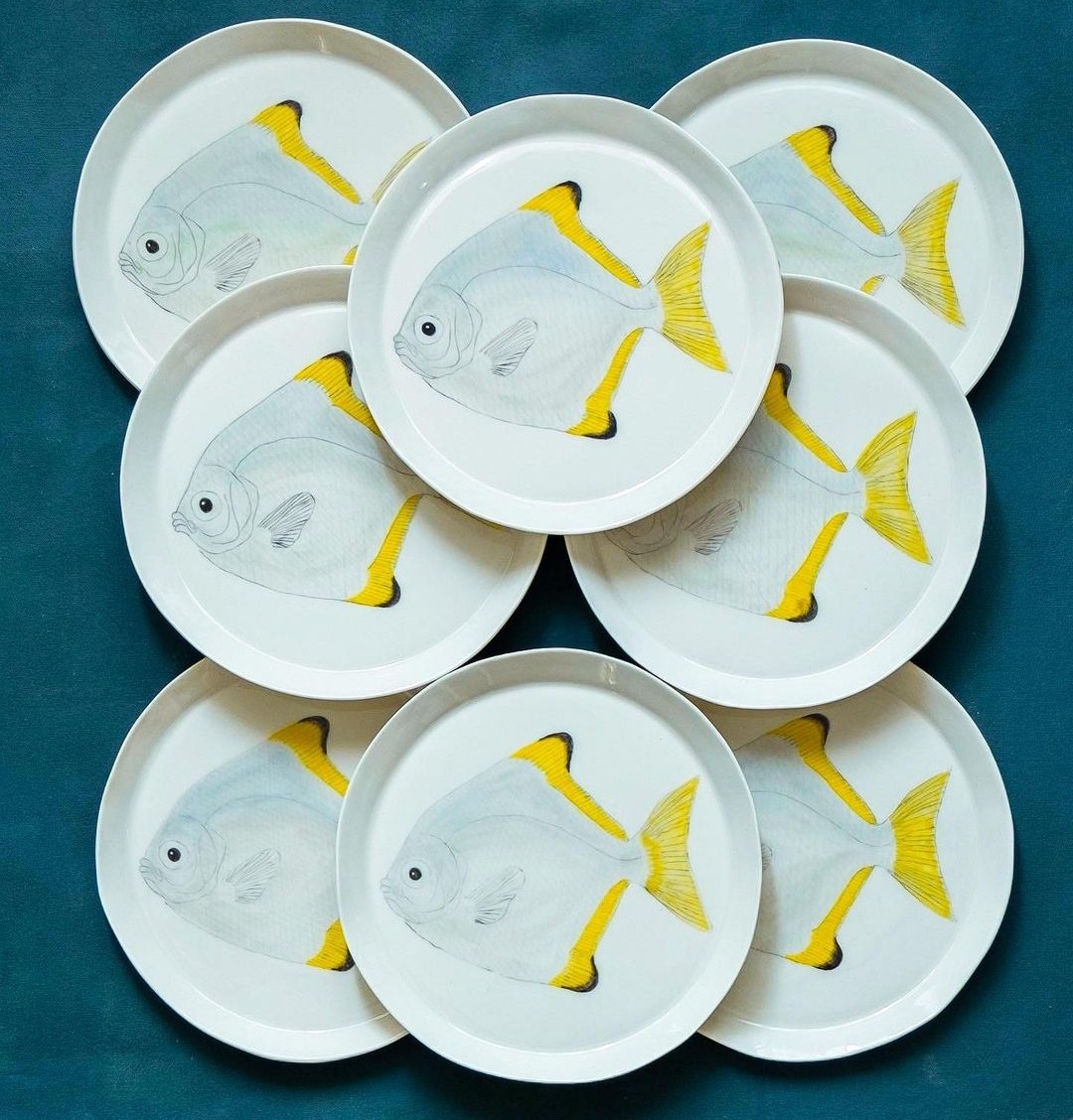 Yellow and white fish plates by Casa Adams Fine Wares