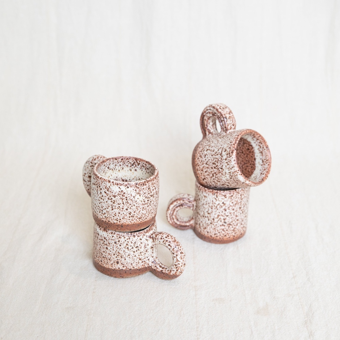 Stack of 4 mini speckled mugs by Ochre Ceramics