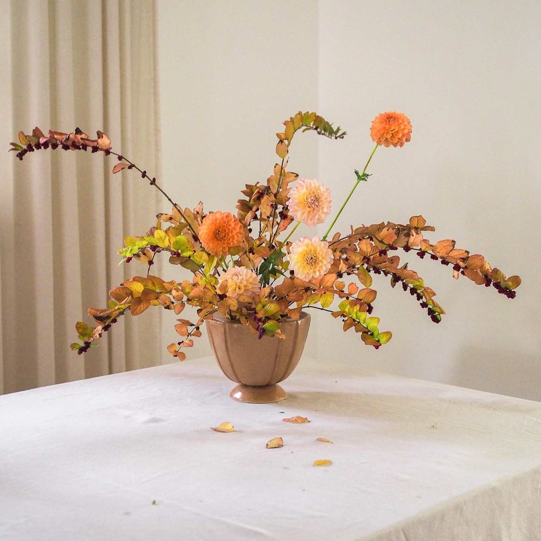 Vase with floral arrangement by Ochre Ceramics