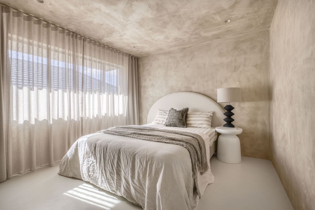 Bedroom in Ruin X house with neutral colour palette