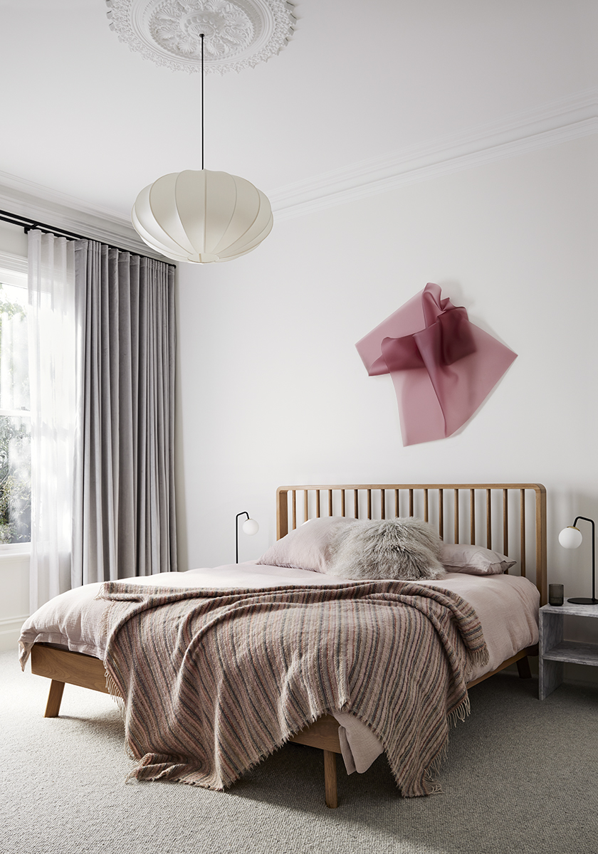 Master bedroom with pink art accents in Elsternwick House