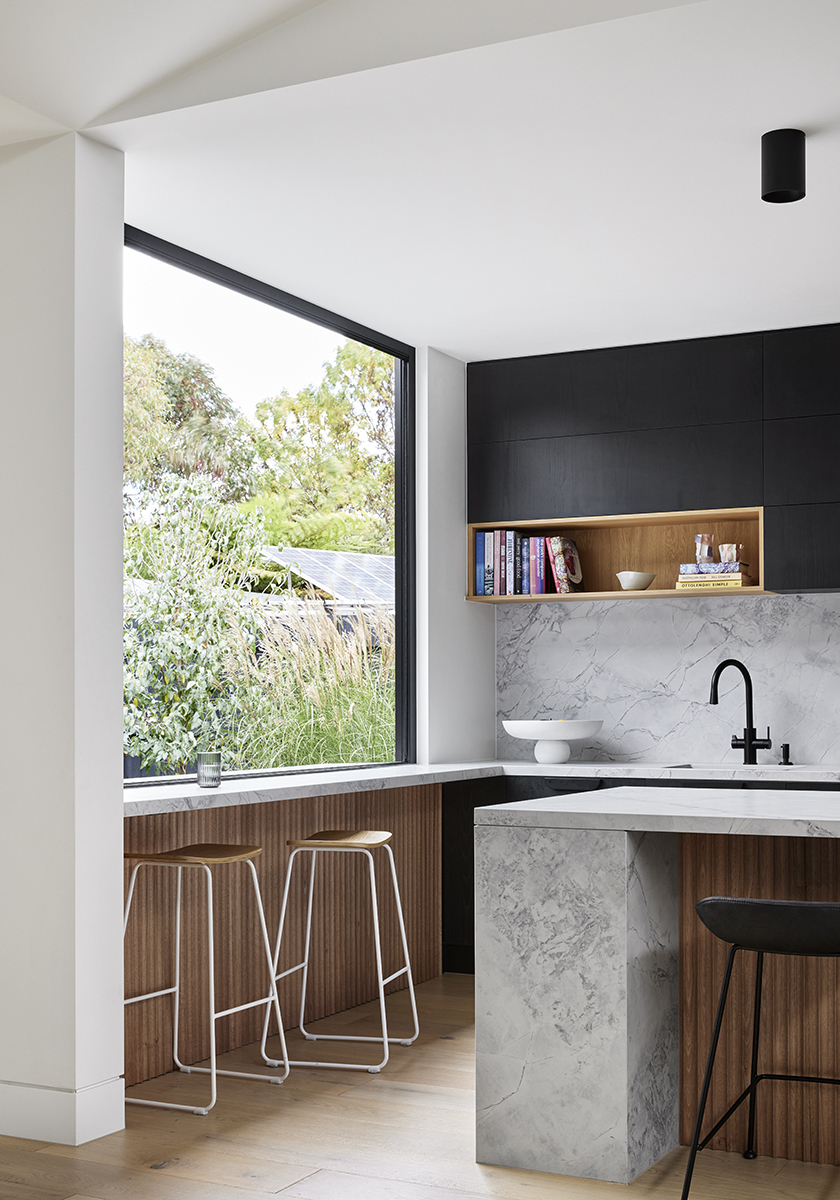 Breakfast bar by window in kitchen of Elsterwick House