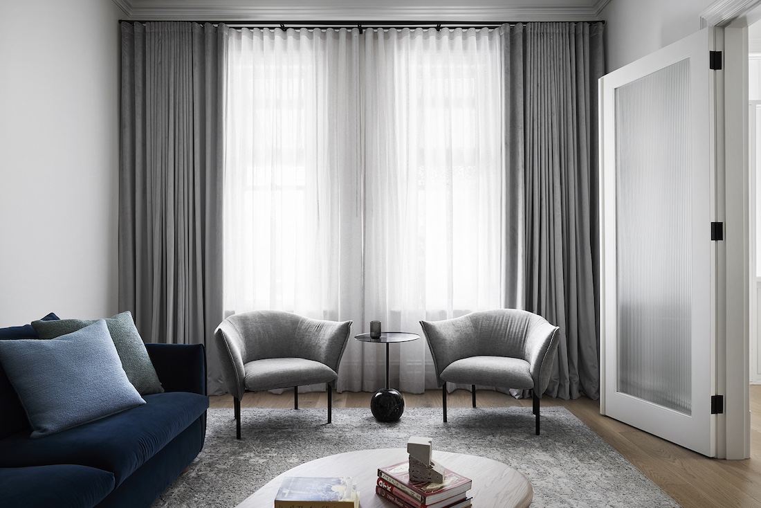 White and grey living room with grey occasional chairs