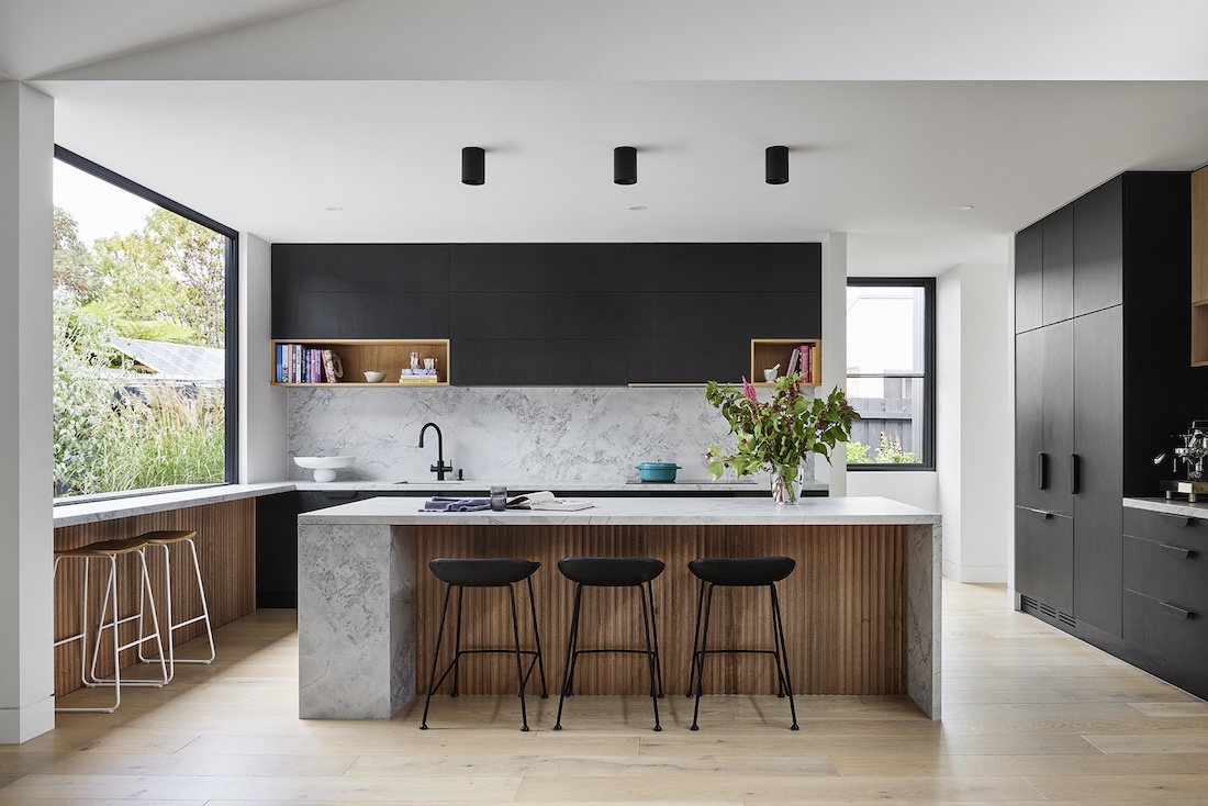 Timber and grey stone island bench in kitchen