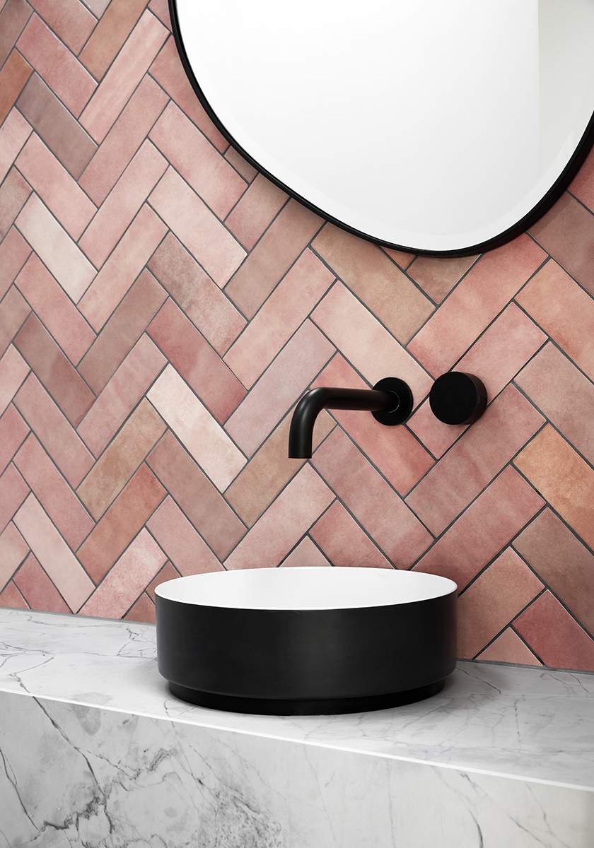 Pink terracotta herringbone tiles in bathroom of Elsternwick House