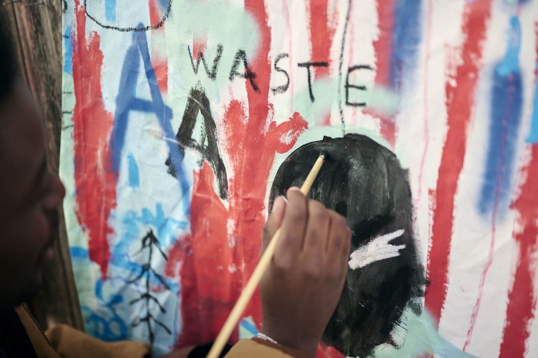 Musonga Mbogo painting in backyard