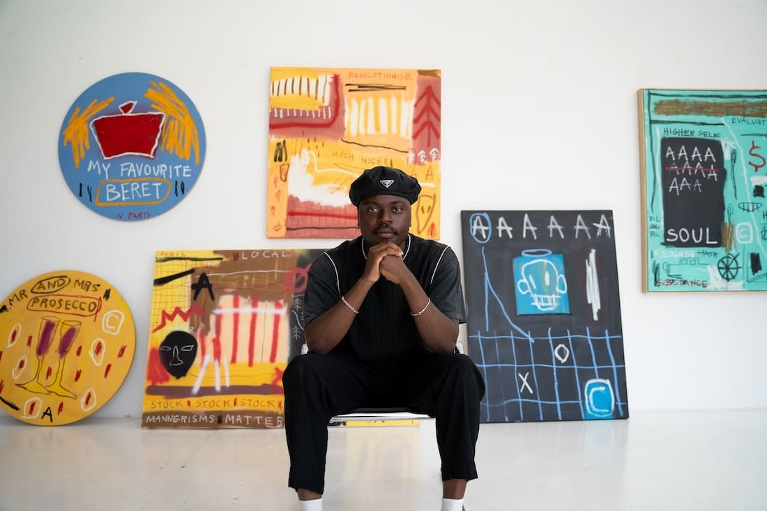 Artist Musonga Mbogo with his artworks