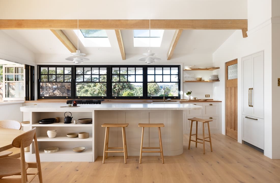 Black framed windows behind island bench in Rocklee House