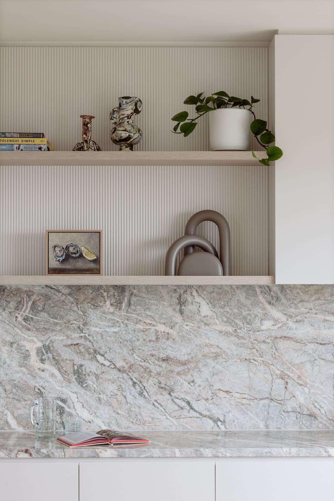 Open kitchen shelves over marble splashback in kitchen makeover