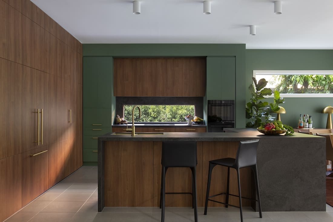 Kitchen island in Warm Embrace residence by The Stylesmiths