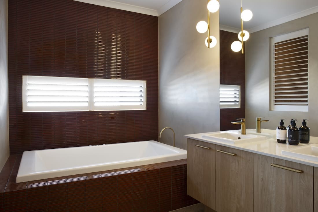 Rust colour tiled bathroom in Warm Embrace residence by The Stylesmiths