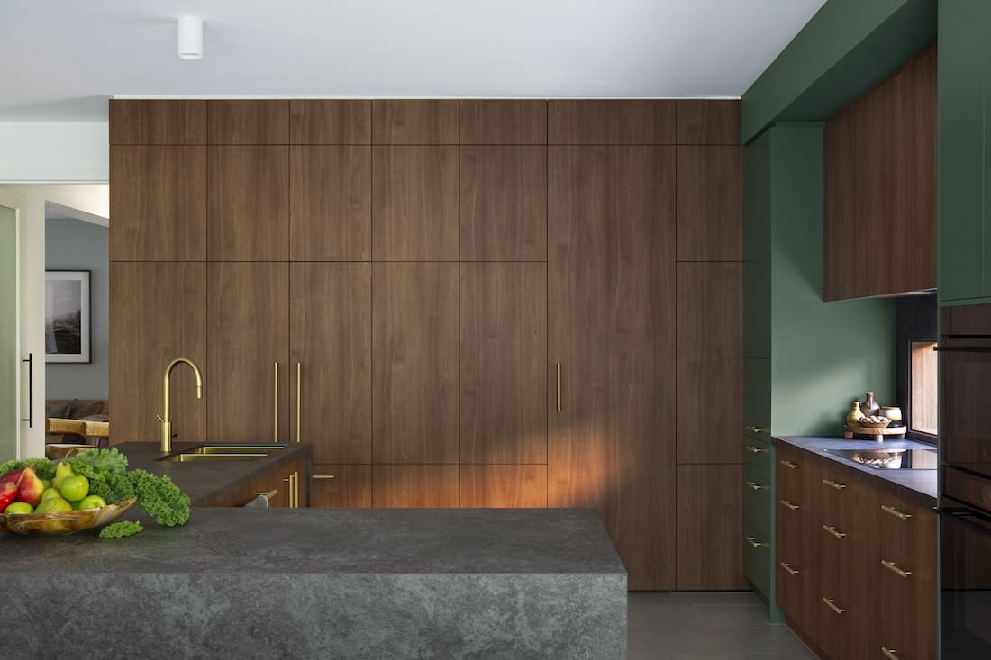 Integrated appliances in Warm Embrace residence by The Stylesmiths kitchen