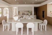 Dining and kitchen with heavily veined marble benchtop at Gréce