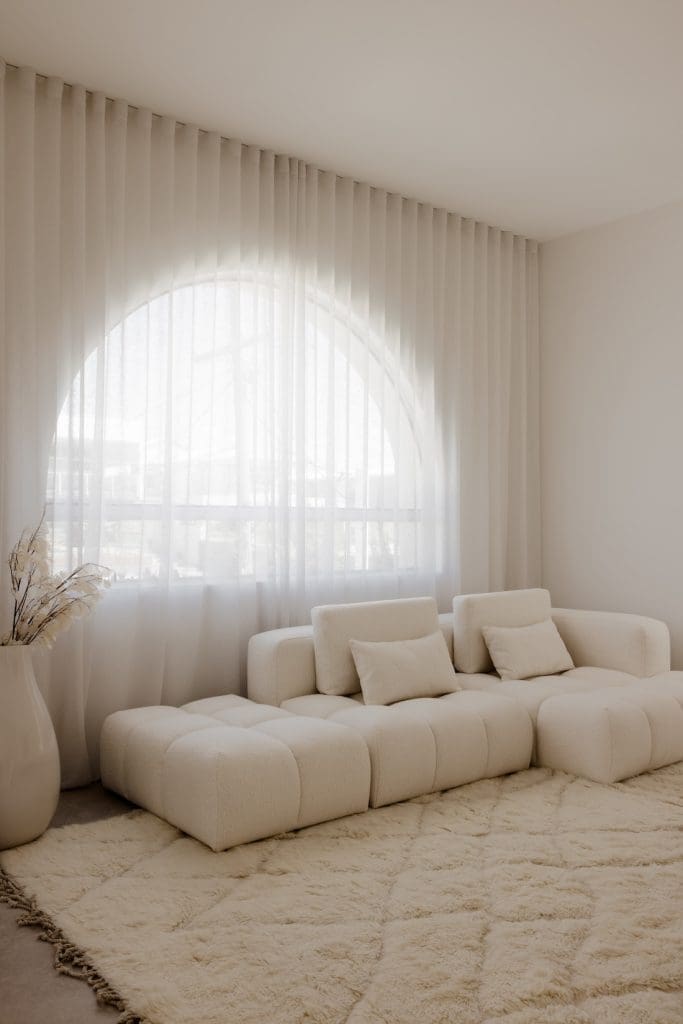 Arch window with plush sofa at Gréce