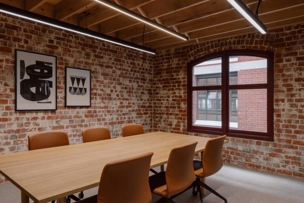 Brick conference room with leather office chairs