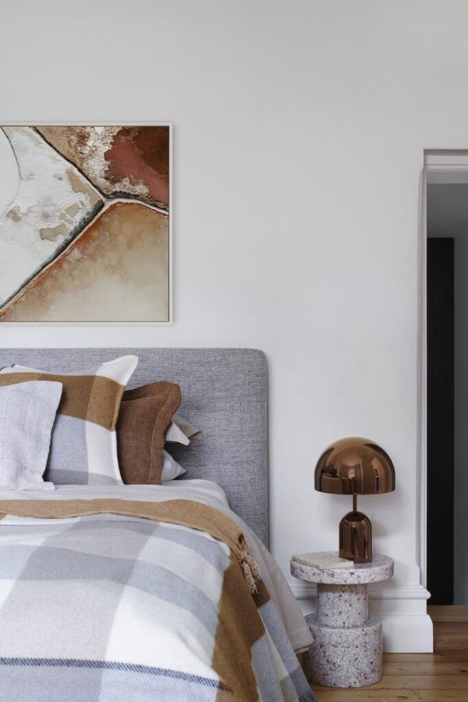 Calm bedroom at Bluestone Sanctuary featuring neutral bedding, abstract artwork and sculptural bedside lamp, styled by The Stylesmiths with architecture by YDM Studio.