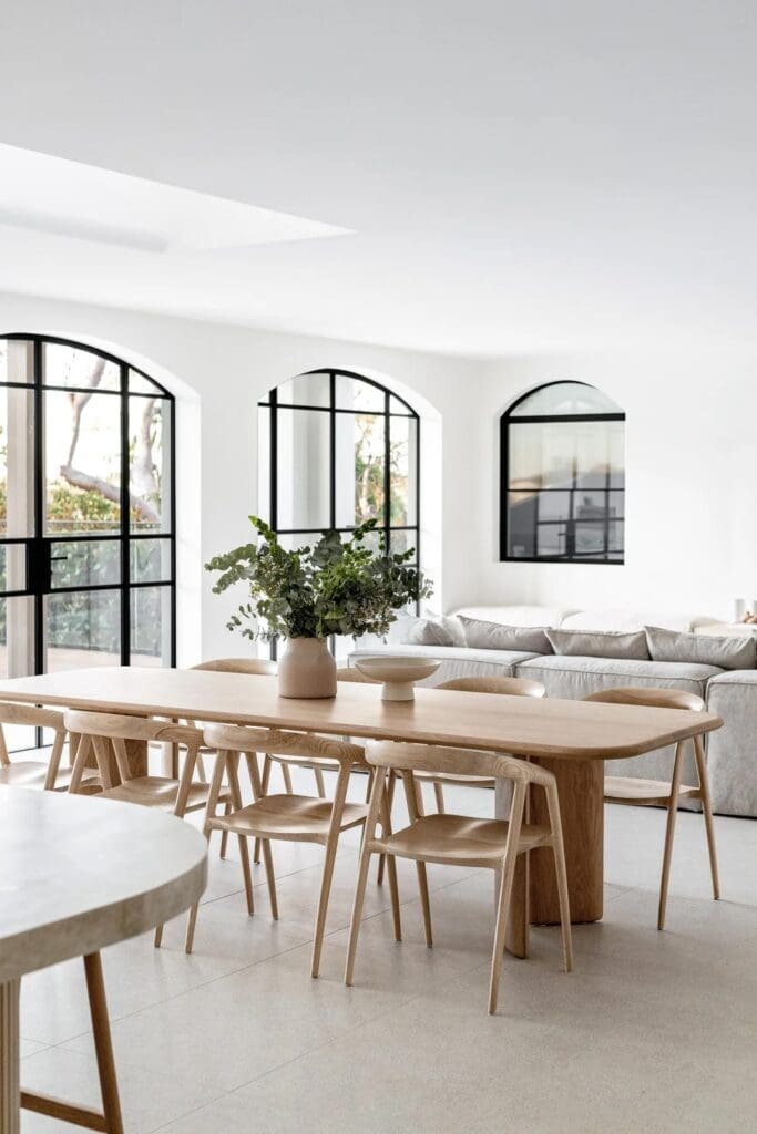 Black steel framed windows and doors in open plan living dining and kitchen at The Stables Burraneer House
