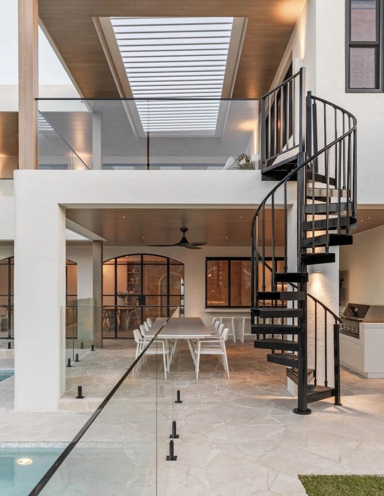 Spiral black steel staircase at back of house at The Stables Burraneer House